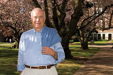 Dan Evans stands amongst UW's cherry blossoms.