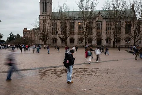 Students walk across Red Square on the University of Washington campus.