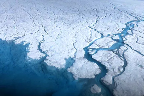 An aerial view of a large ice sheet in Greenland.