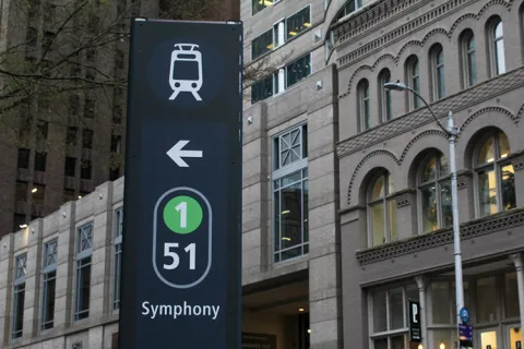 A sign for Seattle's tram that shows the 1 line and symphony stop.