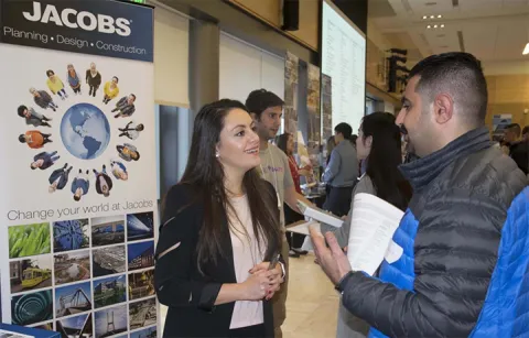 student talking to recruiter at career fair