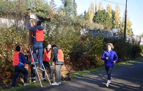 A runner running past a group of researchers