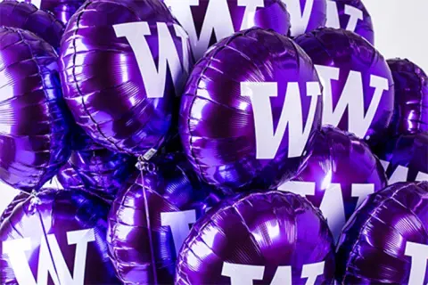 Purple balloons with a W on them