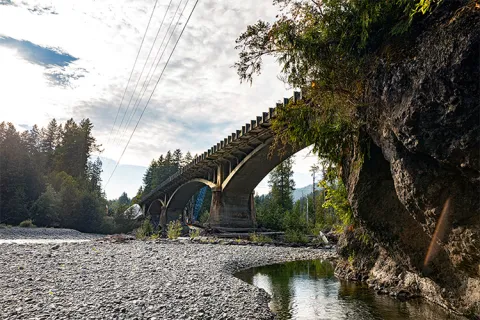 A concrete bridge going over the Elwha River