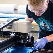 Person working with industrial machinery in a lab