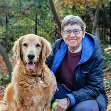 Deb Niemeier and a golden retriever dog sitting together