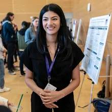 Person smiling to camera during capstone event